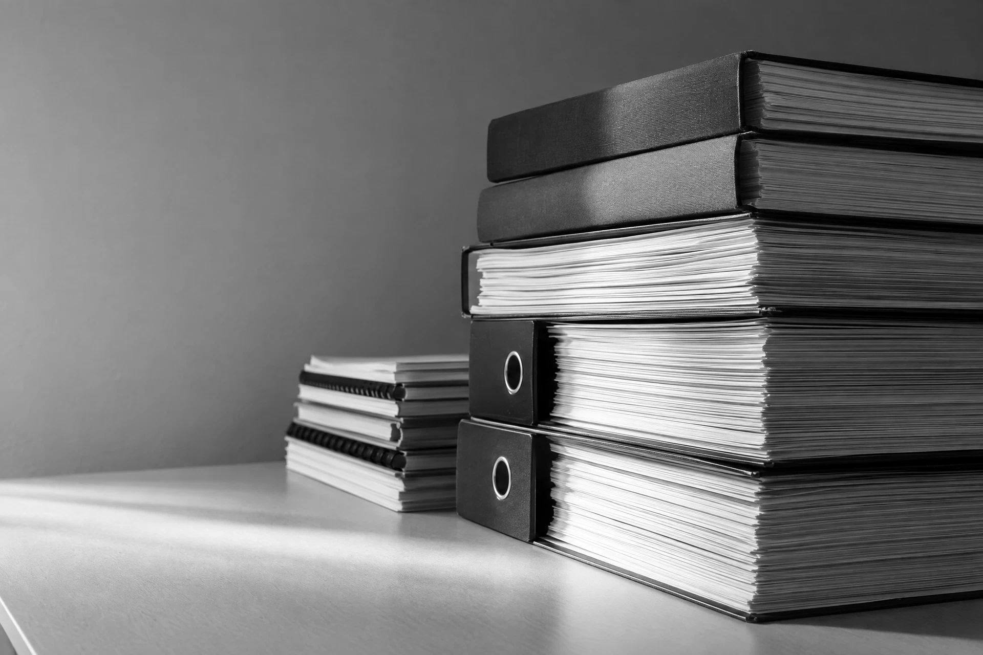Stacks of bound reports in raking light